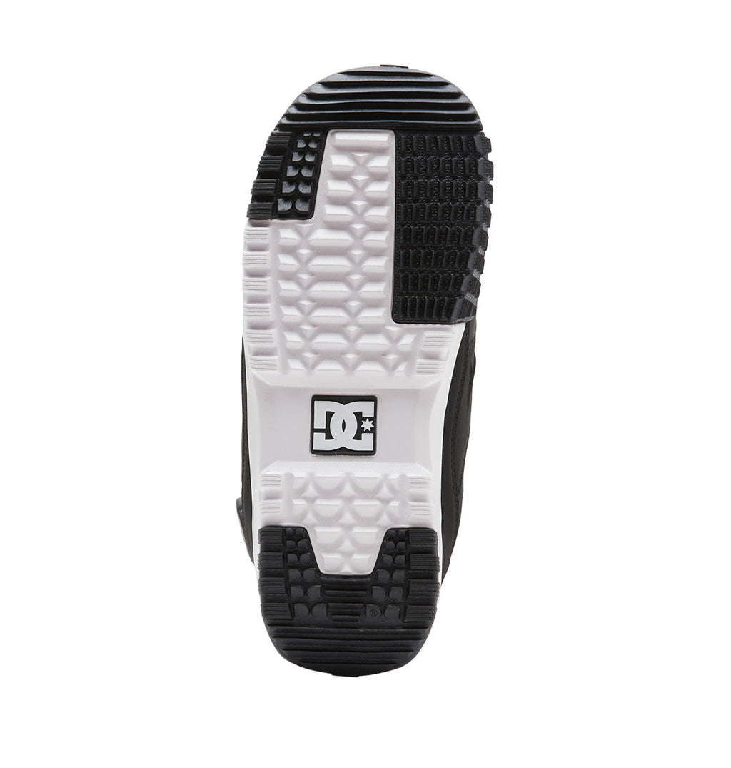 The sole of a black and white DC Shoes Men’s Premier Hybrid BOA® Snowboard Boot features a textured pattern with the DC logo in the center, inspired by the design of their skate shoes.