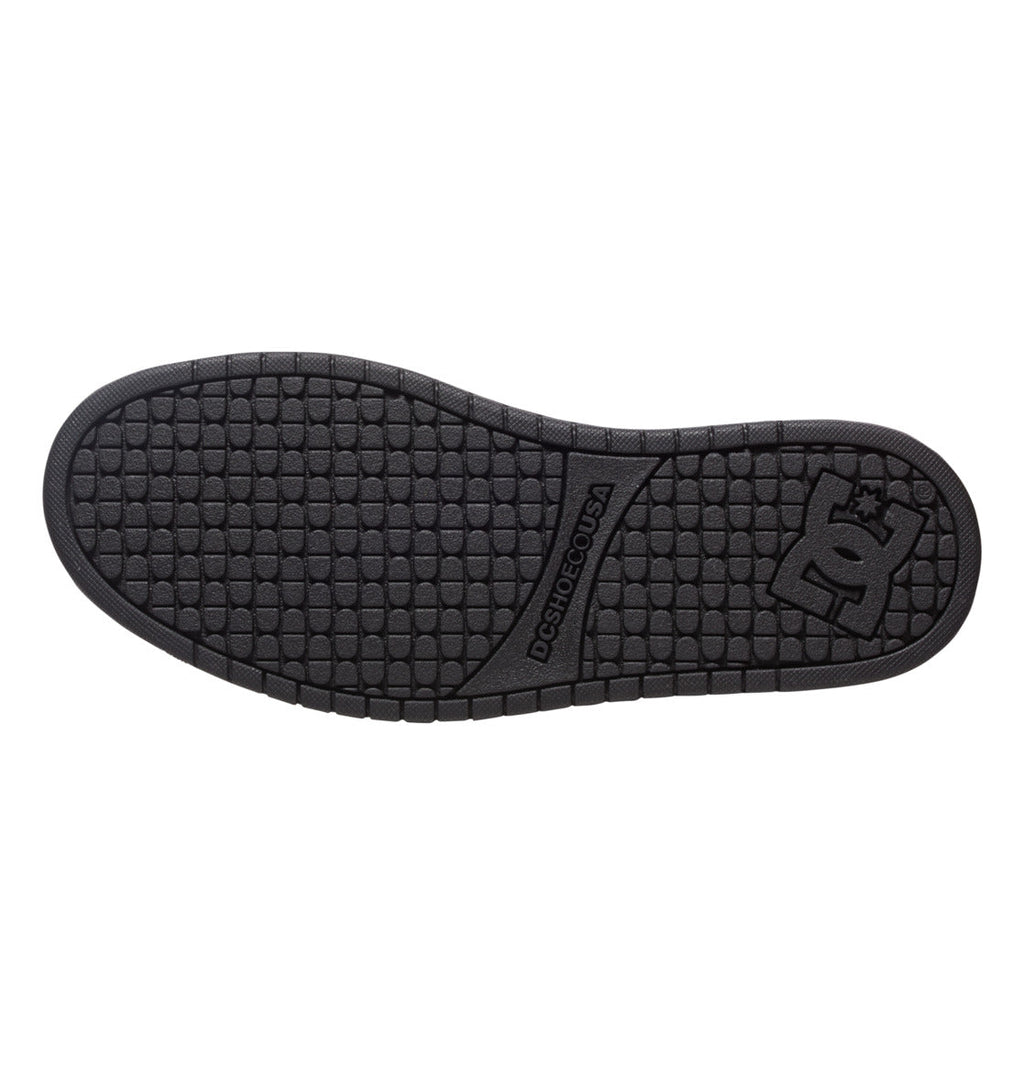 The Men’s Court Graffik Shoes from DC Shoes feature a black rubber sole with a textured, square-pattern grip and DCSHOECOUSA text. Near the heel, the iconic DC logo accents the signature puffy silhouette of this classic style.