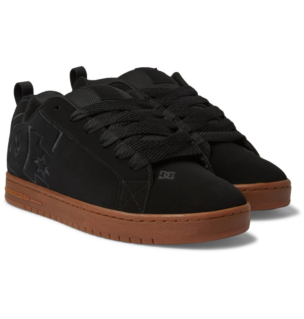 A pair of DC Shoes Men’s Court Graffik Shoes in black, featuring thick black laces, signature black DC logo details, brown rubber soles, and the classic puffy silhouette, displayed on a white background.