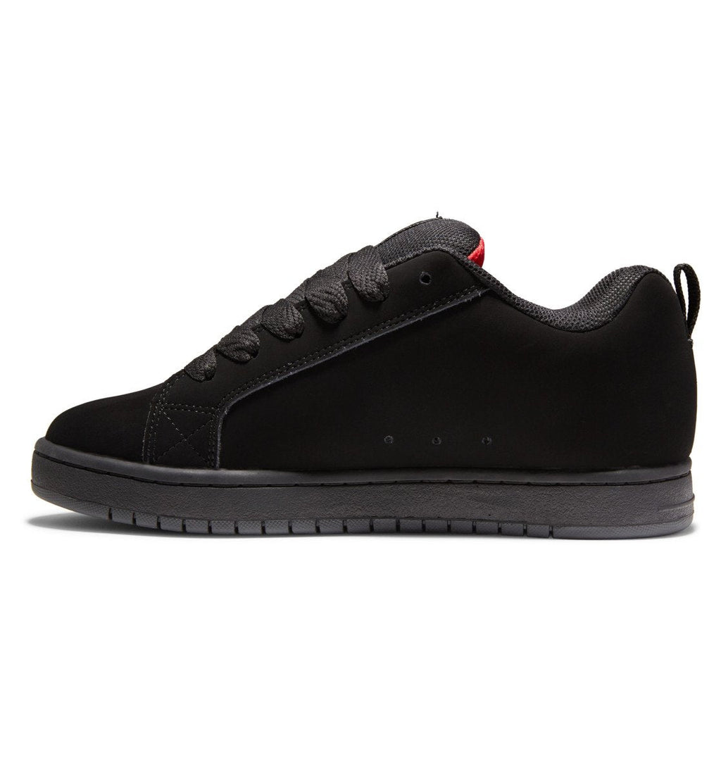A black low-top shoe from DC Shoes, the Men’s Court Graffik Shoes feature matching black laces and sole, subtle stitching accents, and the signature puffy DC logo on the side. Displayed in a left side profile against a white background, this reimagined classic showcases timeless Court Graffik style.
