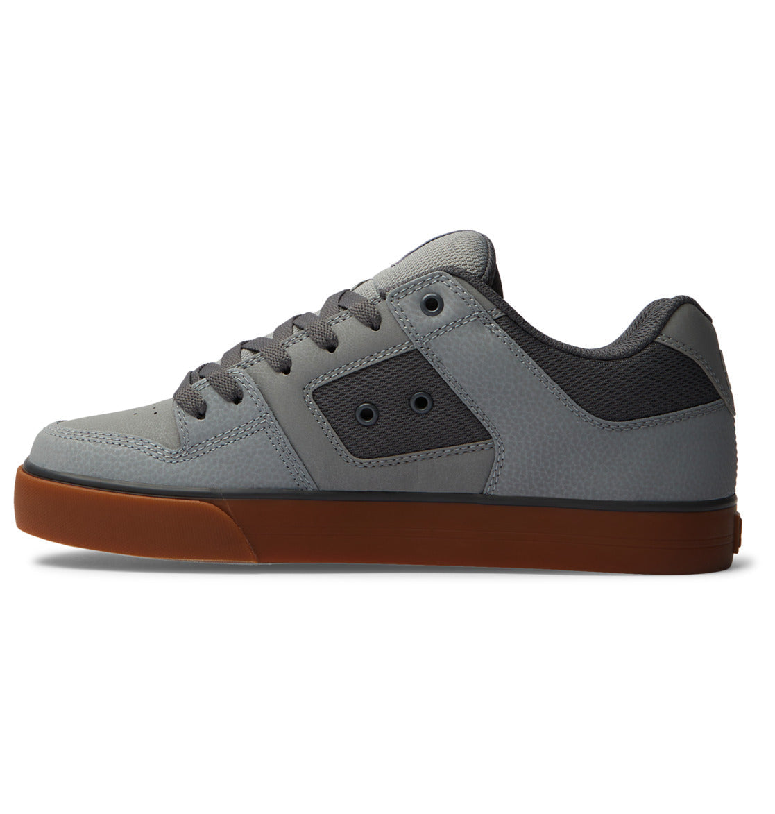 The DC Shoes Men’s Pure Shoes feature a gray low-top design with dark gray laces, black side eyelets, a textured upper, and a brown rubber sole. Shown in profile on a white background, these versatile shoes combine style and comfort for any occasion.