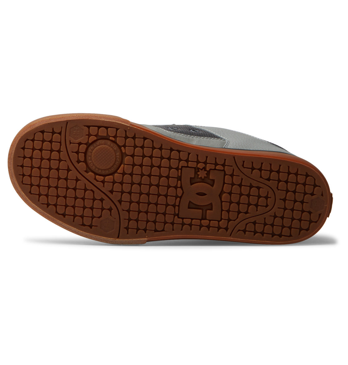 The brown rubber sole of the DC Shoes Men’s Pure Shoes features a textured grip pattern, circular designs, and a stylized star logo at the center. Displayed sole-up against a white background, this versatile and comfortable men’s shoe showcases its standout tread design.