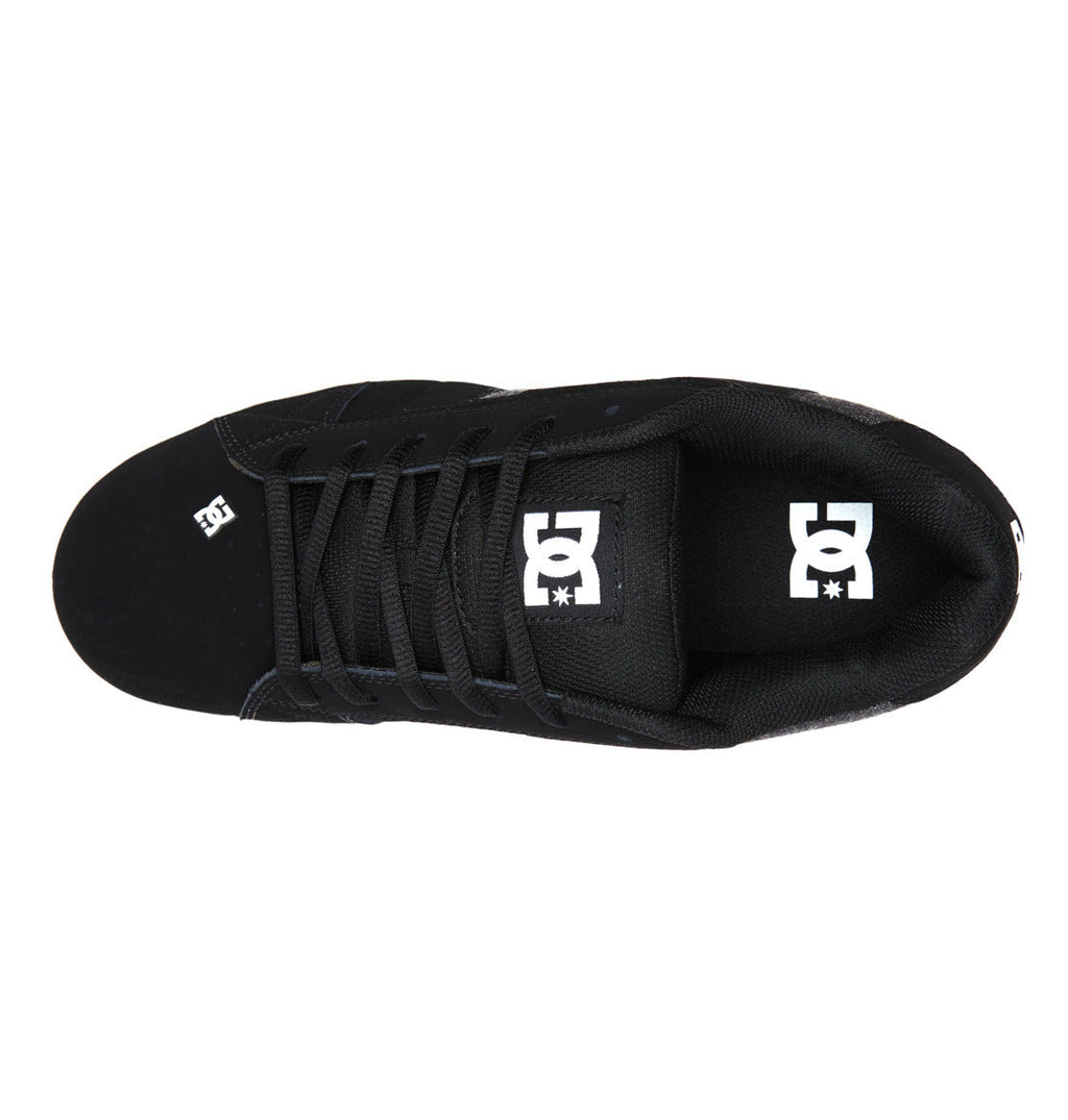 A top-down view of the DC Shoes Men’s Net sneaker in black, showcasing black laces, durable fabric construction, and the iconic white DC Shoes logo on both the tongue and near the toe.