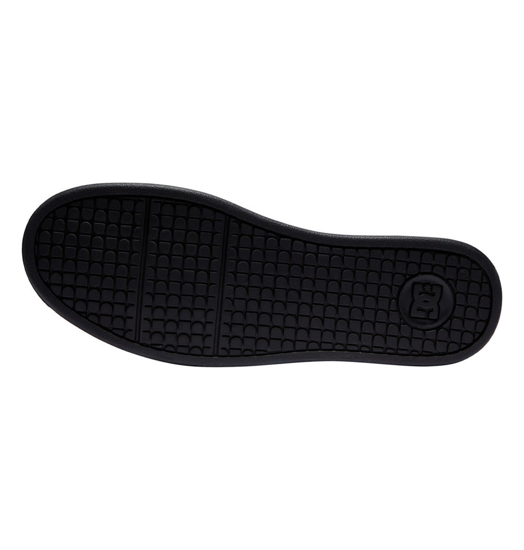 Black sole of the Men’s Net Shoes by DC Shoes, featuring a textured grid pattern and a circular logo with a crown near the heel, set against a white background—an iconic detail present on every pair crafted from durable materials by DC Shoes.