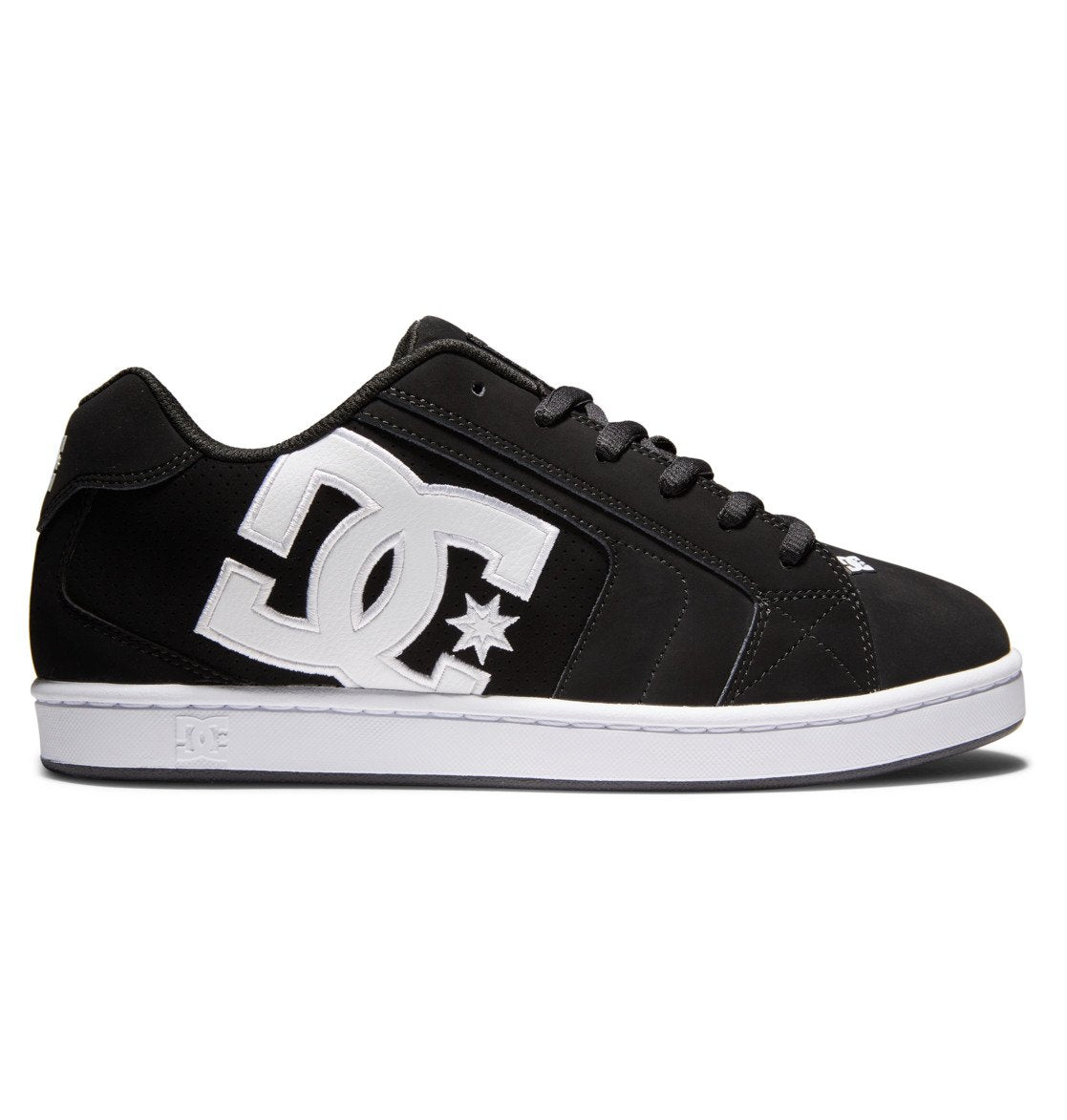 A side view of the Men’s Net Shoes by DC Shoes, featuring a black design crafted from durable materials, with a prominent white DC logo and star on the side, bold branding details, black laces, and a white sole, set against a white background.