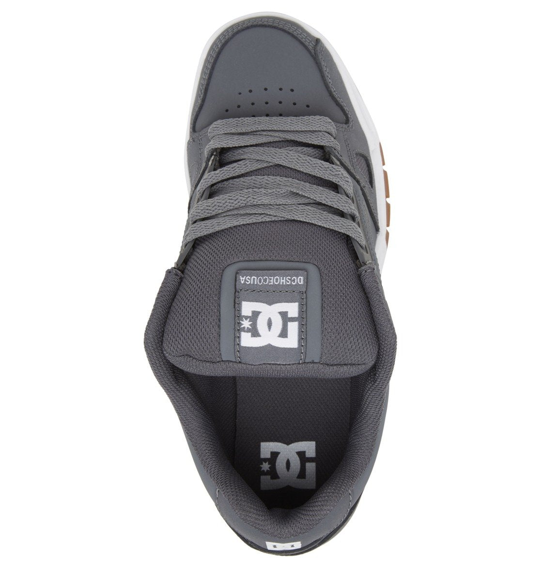 Top view of the DC Shoes Men’s Stag Shoe in grey, showcasing oversized puff detailing, a white DC logo on the tongue and insole, grey laces, and a durable cupsole with a gum brown accent visible along the side.