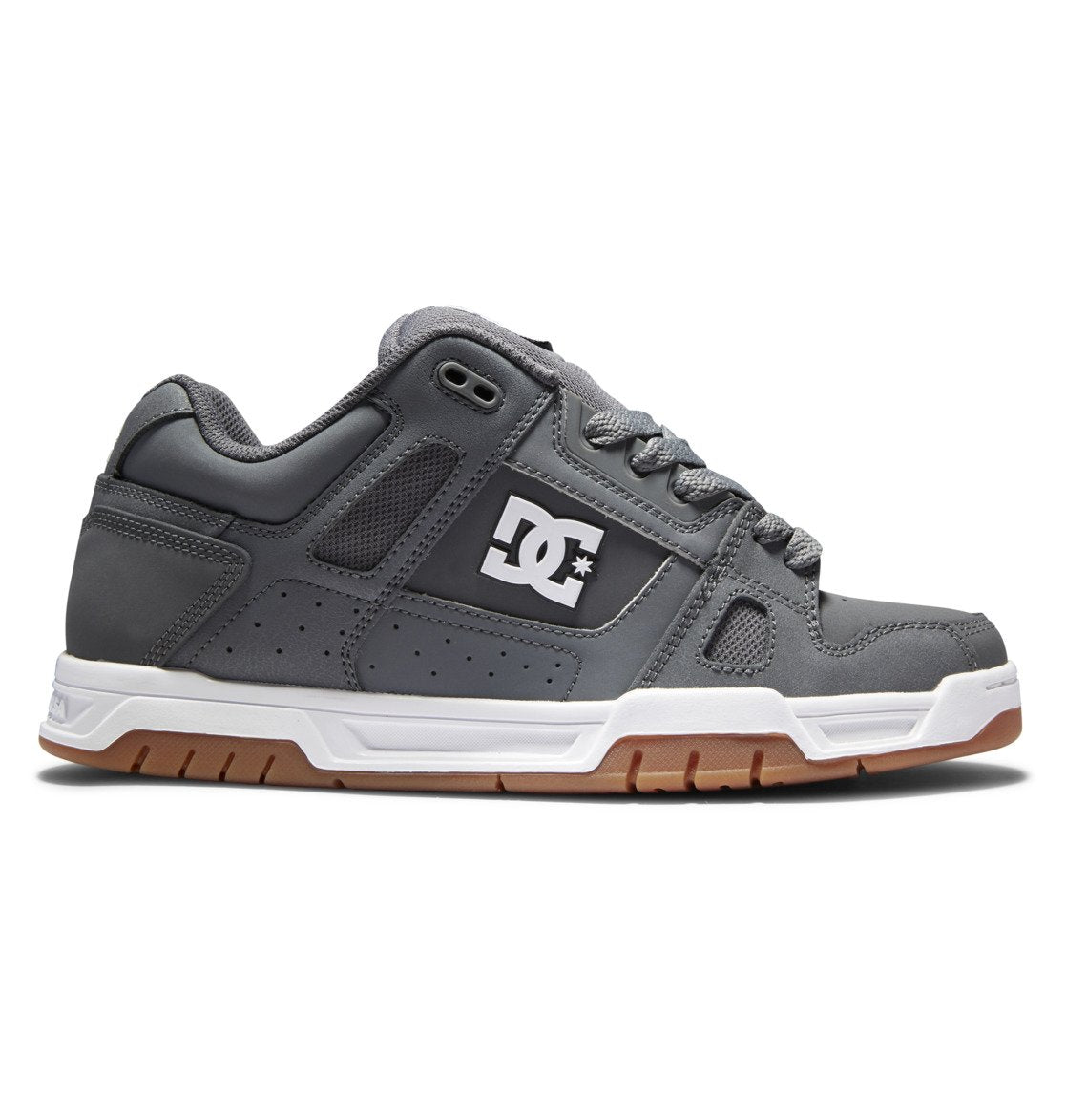 Introducing the Men’s Stag Shoes by DC Shoes: these sneakers feature a sleek gray upper with a white sole and brown tread, highlighted by the signature DC logo in white on the side. The design includes gray laces, black trim accents, and a durable cupsole crafted for long-lasting wear.