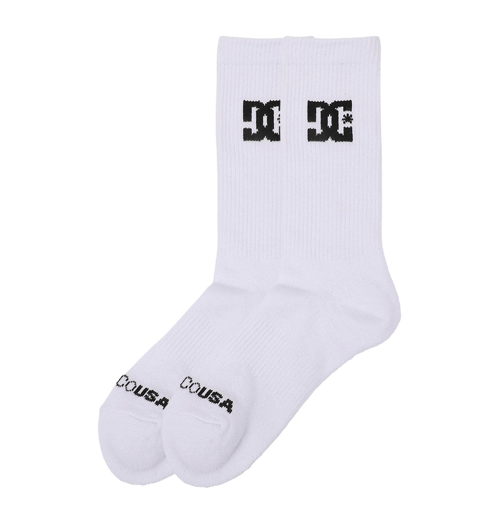 The DC Shoes Crew Socks 6-Pack features white crew socks with a black DC Shoes logo on the front and "COUSA" printed near the toes, shown side by side on a plain white background.