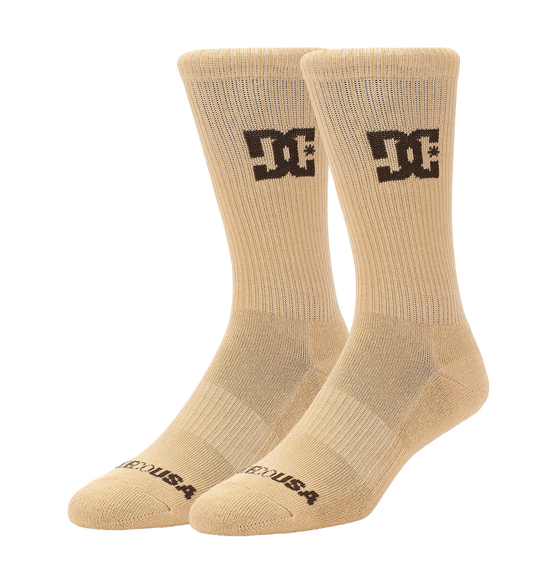 A 6-pack of beige crew socks by DC Shoes, each featuring a black logo on the side and “DC USA” text on the toe, displayed upright against a white background.