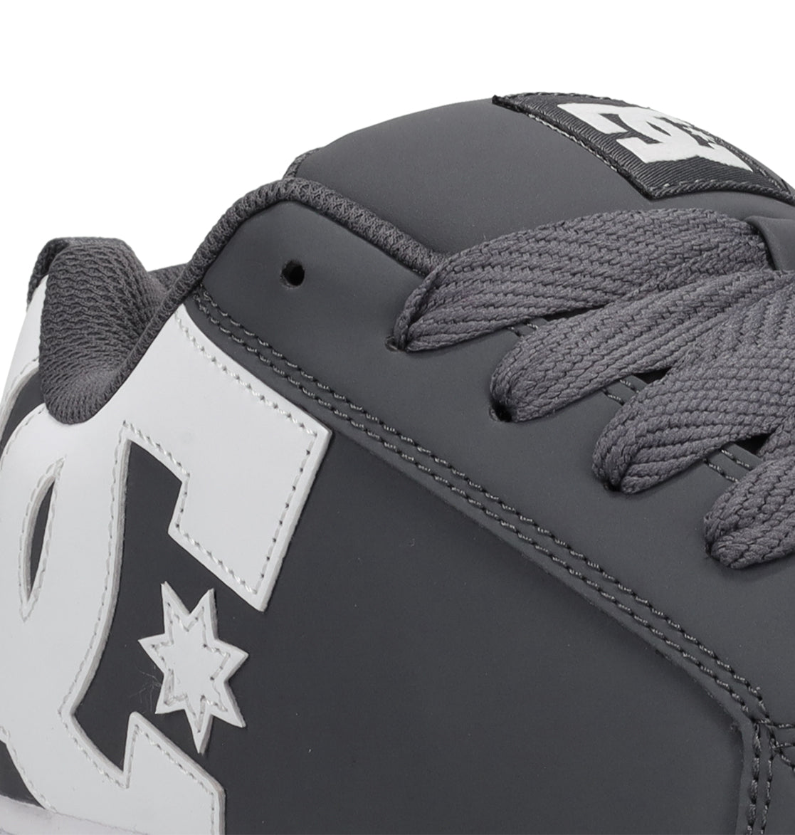 Close-up of the Men’s Court Graffik Shoes by DC Shoes, showcasing their signature chunky skate silhouette in grey with thick matching laces and a prominent white DC Shoes logo on the side. The detailed stitching and textured materials are clearly visible.