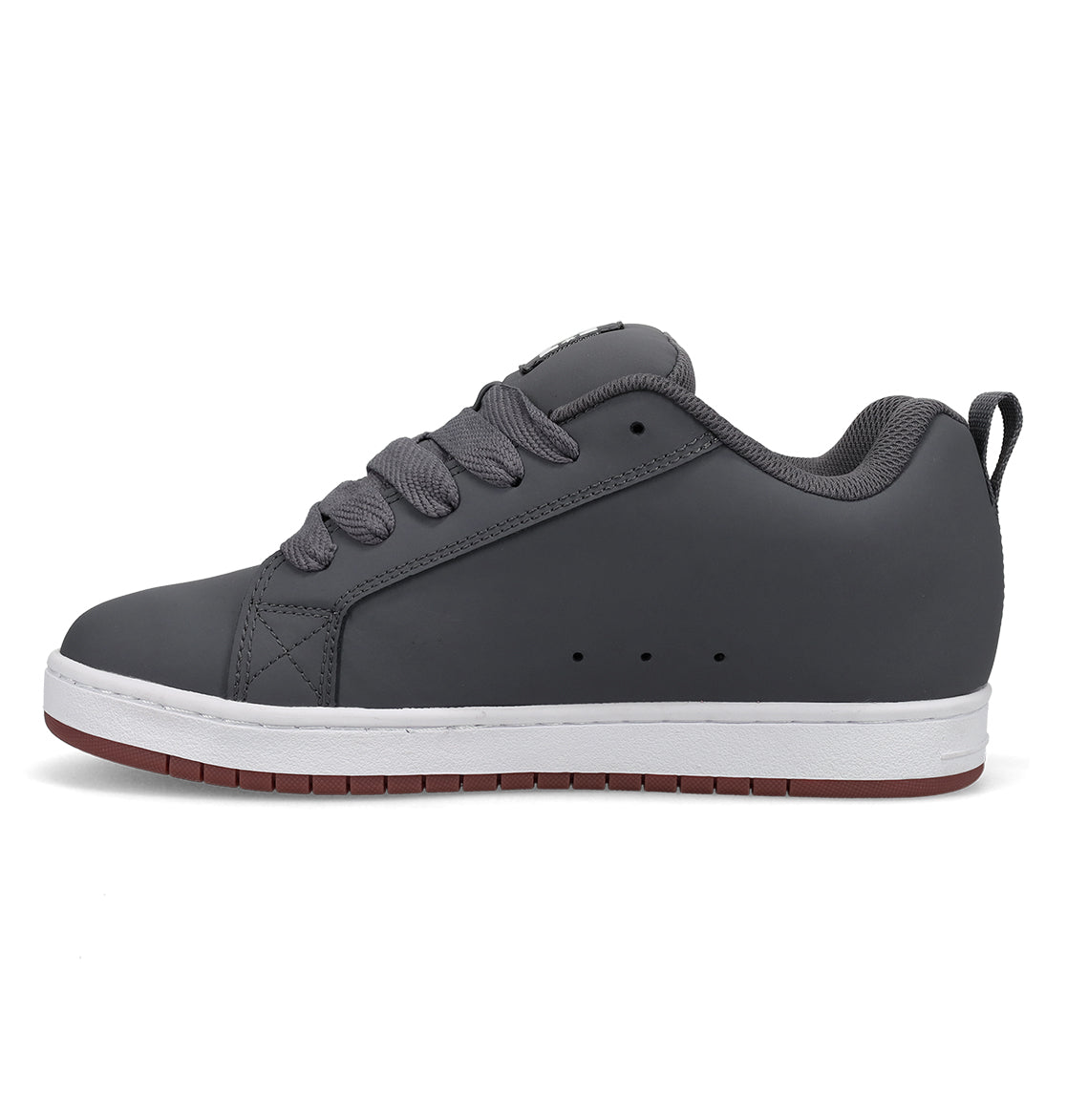 The DC Shoes Men’s Court Graffik Shoes are grey low-top sneakers inspired by the iconic Court Graffik style, featuring thick laces, a chunky skate shoe profile, a white sole, and a brown bottom. They are displayed from the side on a plain white background.