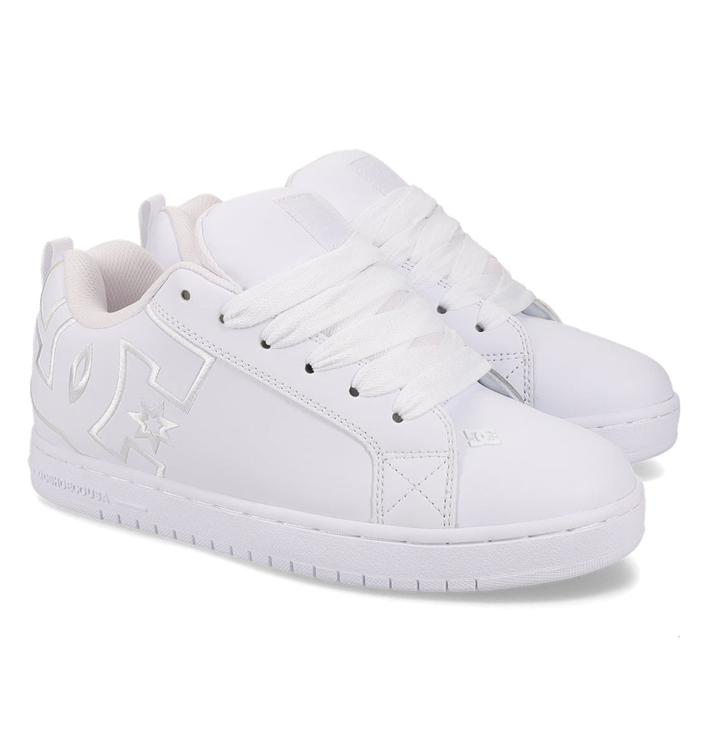 A pair of men’s Court Graffik Shoes by DC Shoes in white, featuring thick white laces and a bold DC logo on the side; these chunky low-top skate sneakers stand out against a plain white background.