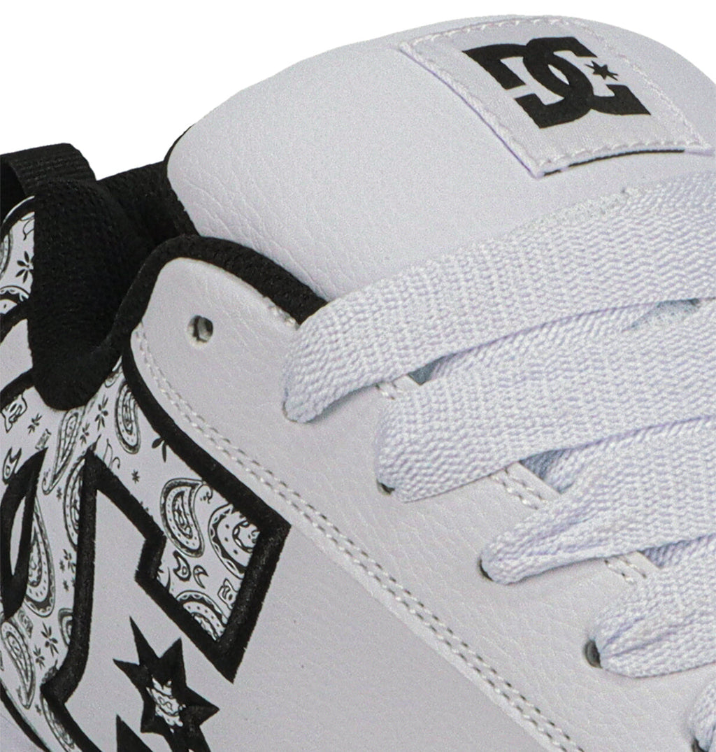 Close-up of DC Shoes Men's Court Graffik, showcasing a puffy white silhouette with black and white paisley inside the bold DC logo, white laces, and black trim accents.
