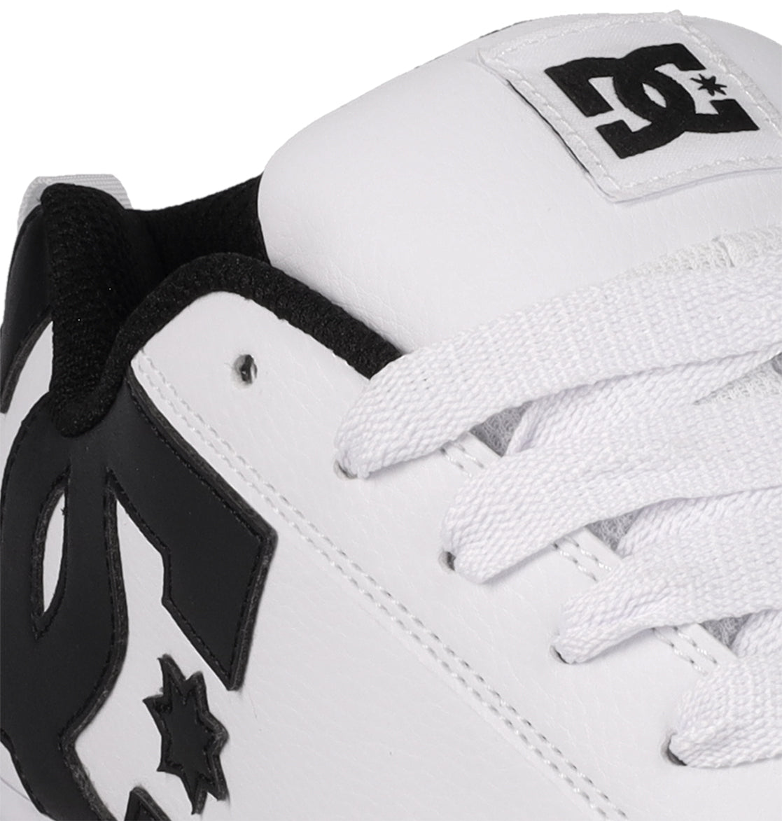 Close-up of the Women's Court Graffik Shoes by DC Shoes: a modern chunky white sneaker with black accents, bold black DC Shoes logos on the side and tongue, and white laces—giving classic '90s style a fresh update.