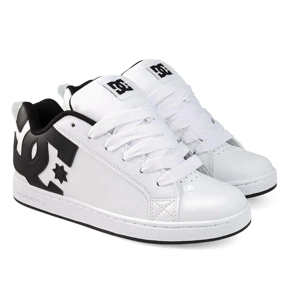 A pair of DC Shoes Women’s Court Graffik shoes in white, showcasing chunky ’90s style with bold black accents, oversized black DC logos on the sides, white laces, and black outsoles, positioned side by side on a plain white background.