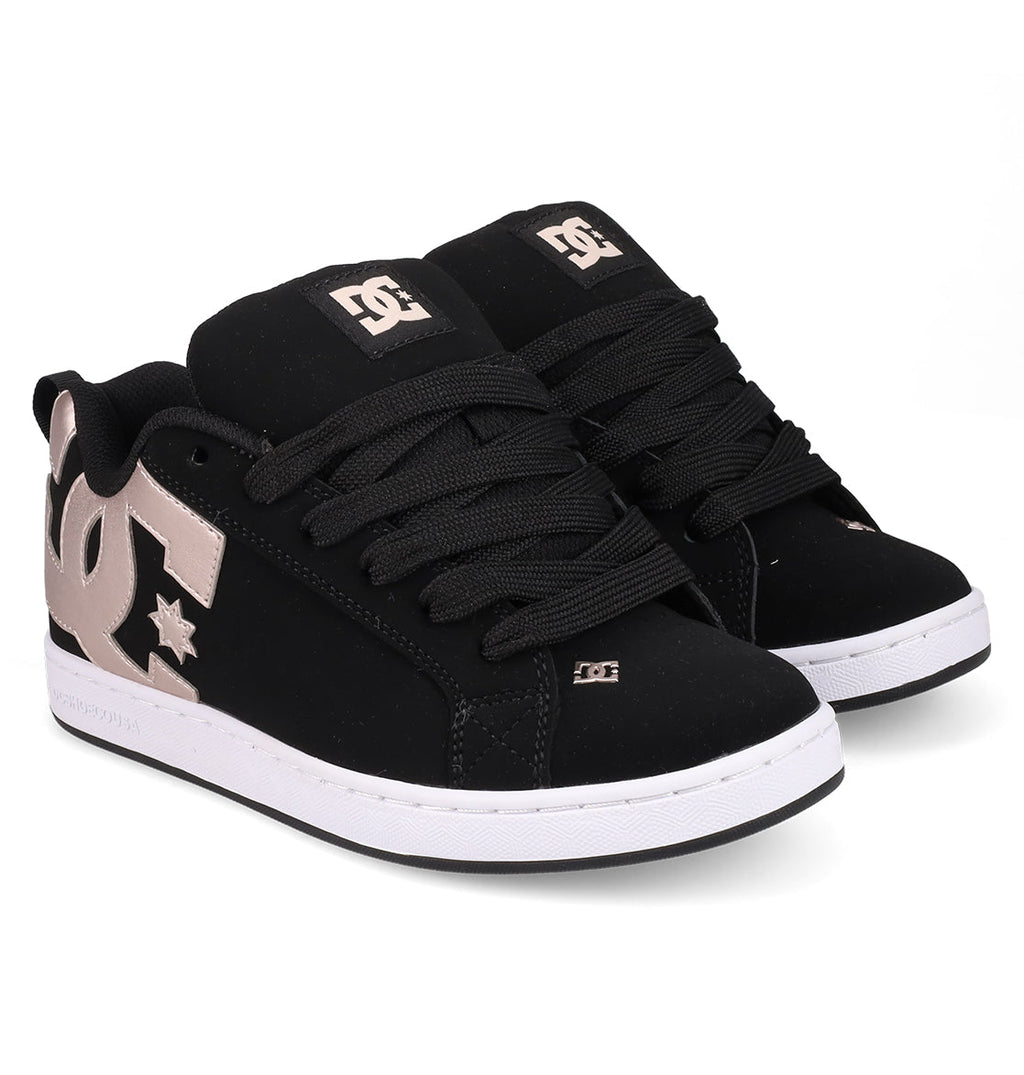A pair of DC Shoes Women's Court Graffik sneakers in black with a puffy silhouette, thick black laces, white soles, and large metallic gold DC logos on the sides and tongues, shown on a white background.