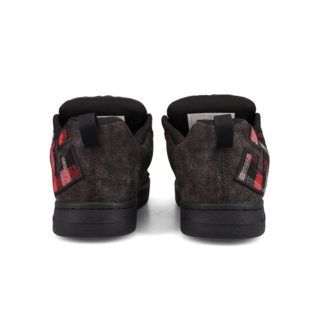 The DC Shoes Men's Court Graffik SE features black low-tops with red and gray checkered heel accents, black soles, and premium upper materials for a stylish and durable finish.
