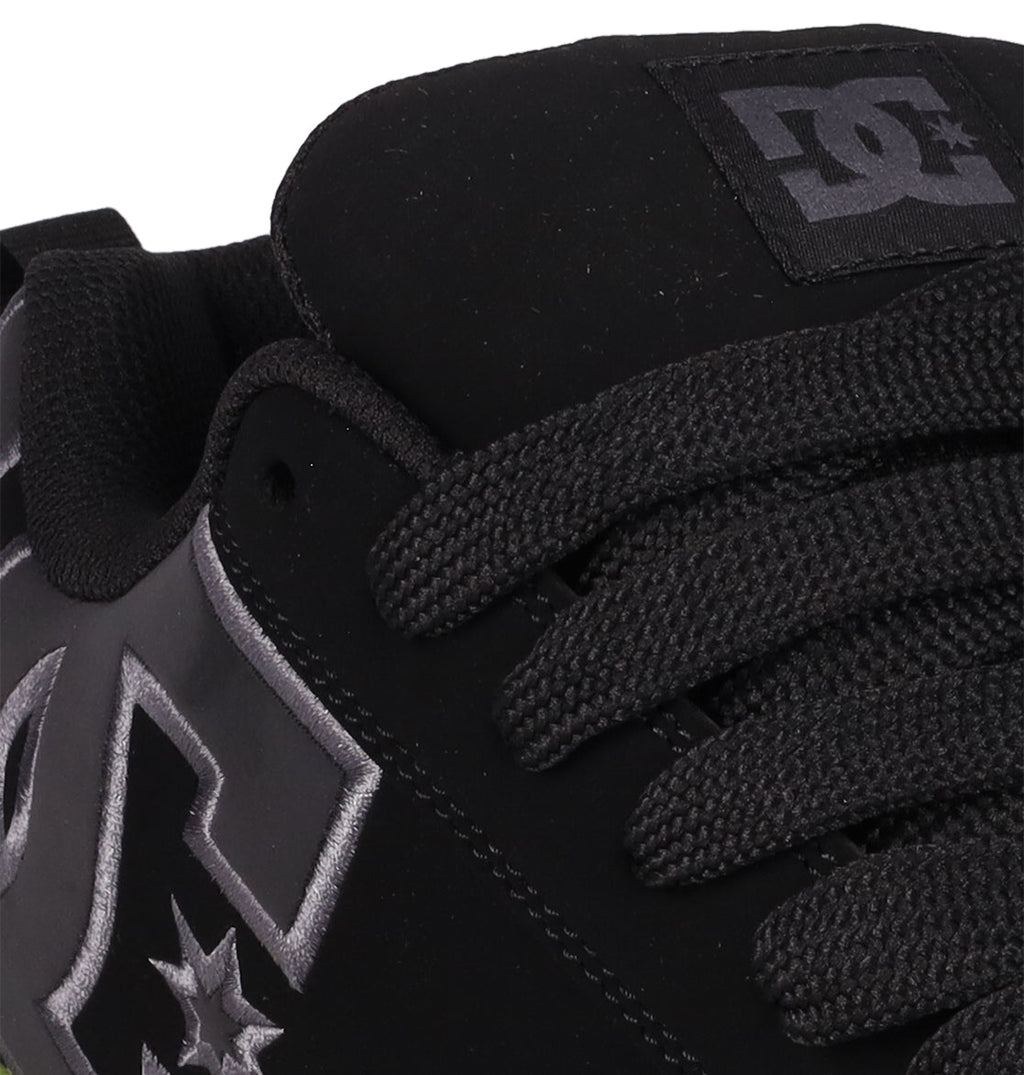 Close-up of the DC Shoes Men's Court Graffik SE—a black skate shoe with a puffy silhouette, thick black laces, and the DC logo in white and gray on the side and tongue.