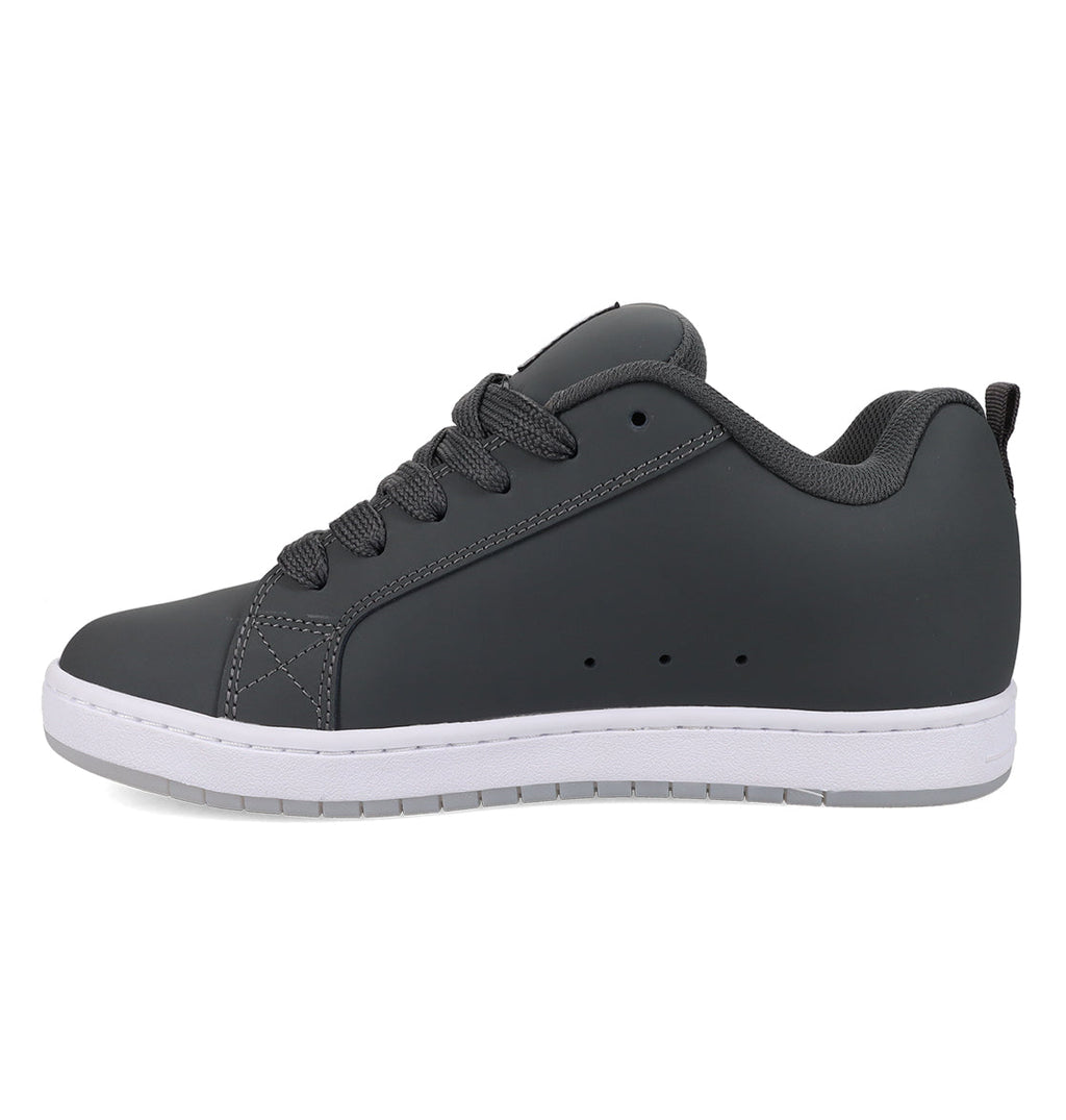 The Men’s Court Graffik Special Edition Shoes by DC Shoes are displayed from a side view on a plain white background. This classic design features a dark gray, puffy silhouette with black laces, a white sole, and the iconic DC logo.