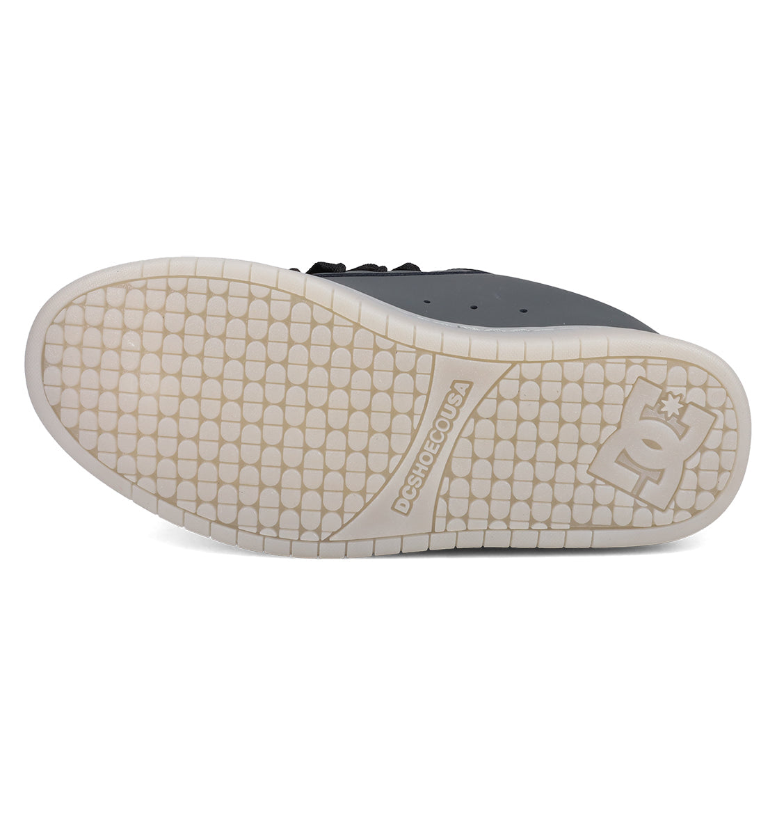 The image shows the white sole of DC Shoes Men's Court Graffik SE Shoes from below, featuring a tread of small raised rectangles and DCSHOECOUSA branding with the DC Shoes logo near the heel—matching its puffy silhouette.