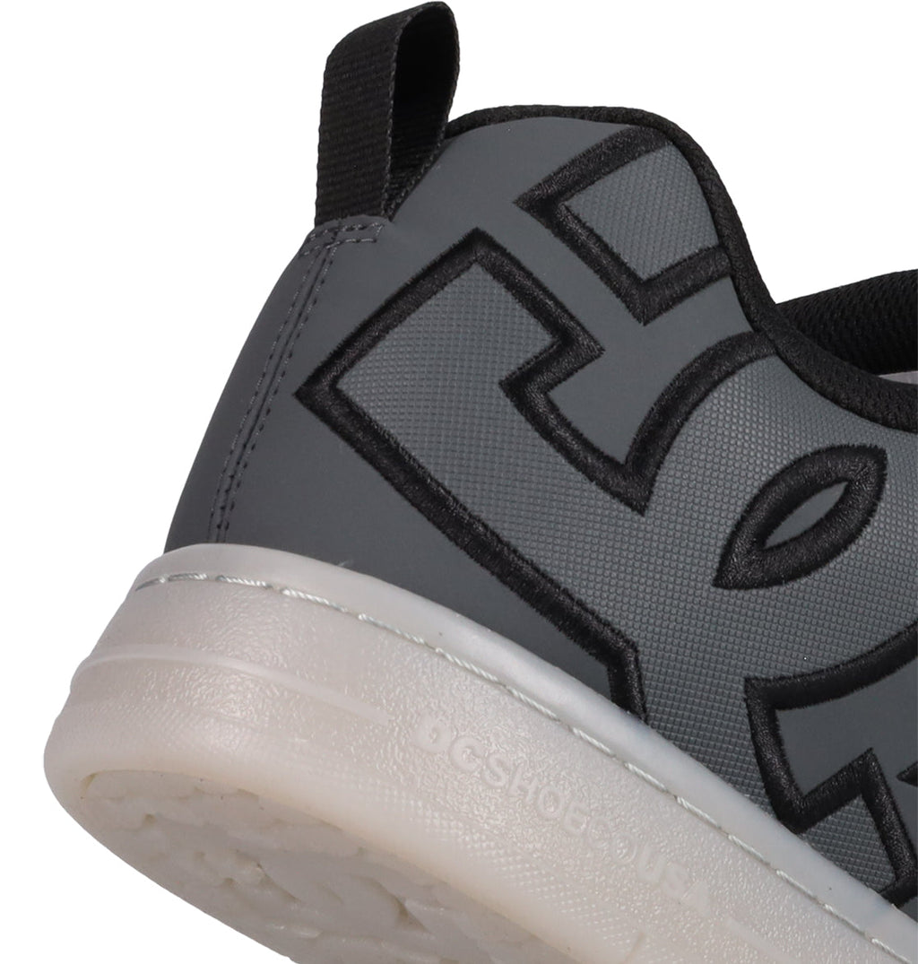 Close-up of the heel and side of the DC Shoes Men's Court Graffik SE, a gray sneaker with bold black stitching, puffy silhouette, white sole, and black heel pull tab for an updated streetwear look.