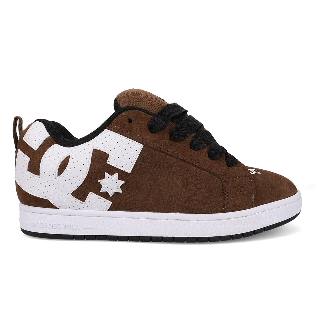 The Men’s Court Graffik Special Edition Shoes from DC Shoes feature a brown suede upper with black laces, white perforated accents, and a prominent white DC logo on the side. Showcasing the iconic puffy Court Graffik silhouette, these shoes have a white sole with a black bottom.