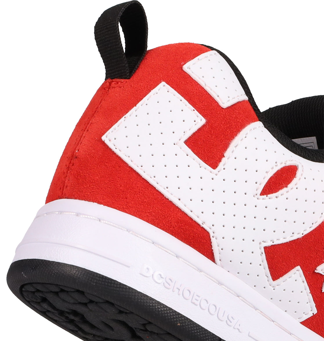 Close-up of the heel and side of DC Shoes Men's Court Graffik SE Shoes in red and white with a black pull tab. Premium upper, white midsole with DCSHOECOUSA embossed, black outsole, and bold white E detail highlight its puffy silhouette.