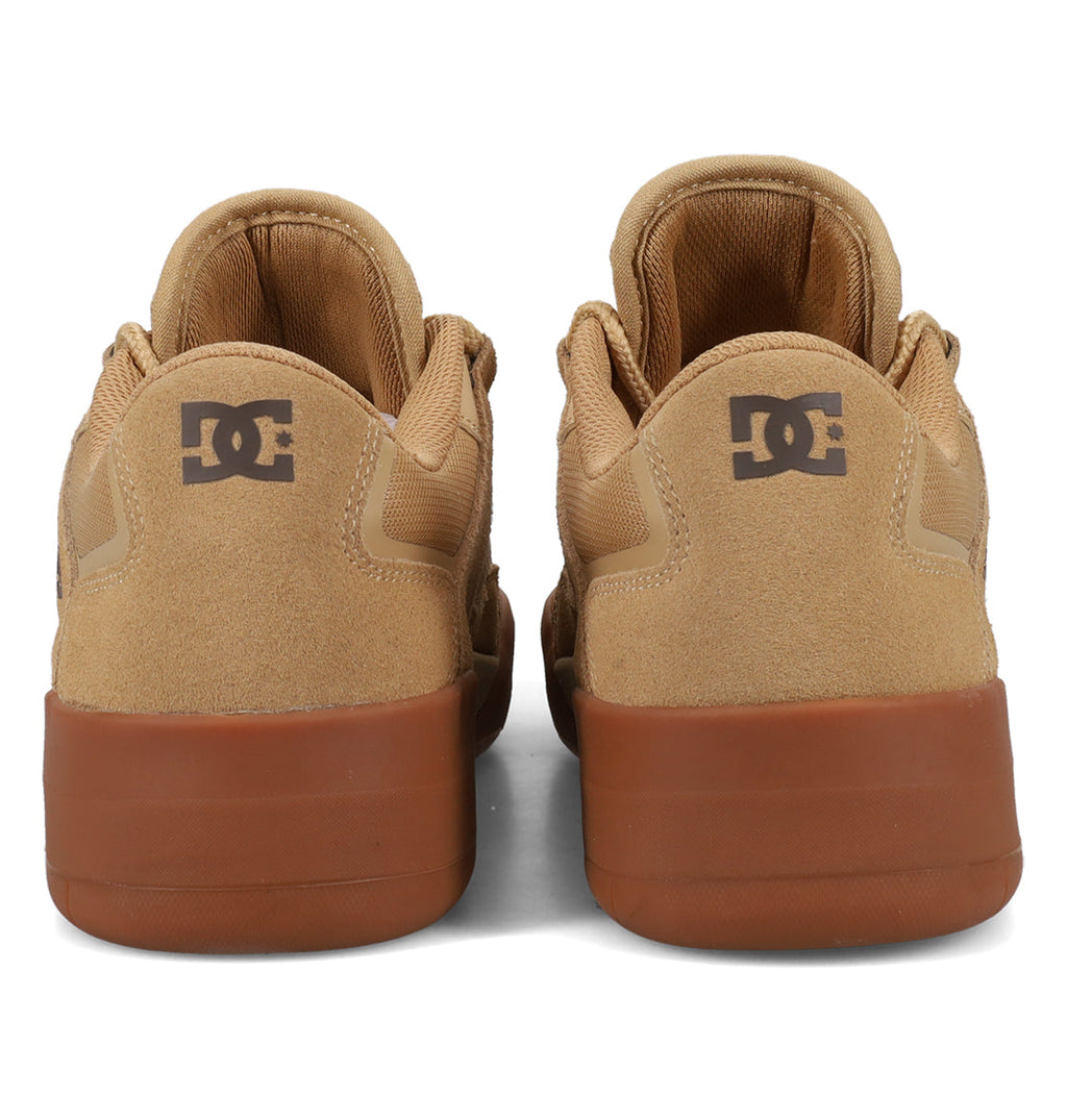 Back view of a pair of tan Men’s Metric Skate Shoes by DC Shoes with brown durable outsoles, featuring the DC logo on the heel. The shoes are placed side by side on a white background.