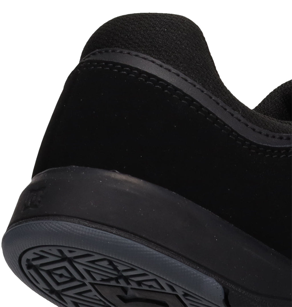 Close-up of the back and sole of the Men’s DC Cure Shoes by DC Shoes, highlighting their textured grip and detailed stitching along the heel and side. These sneakers feature a durable leather suede upper, offering style and comfort for everyday wear.