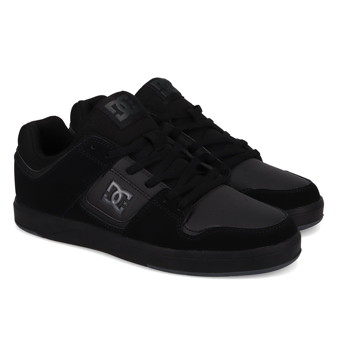A pair of Men’s DC Cure Shoes from DC Shoes, featuring a durable black leather suede upper, lace-up fronts, black soles, and the signature DC logo on the side. The shoes are positioned slightly angled, side by side, against a white background.