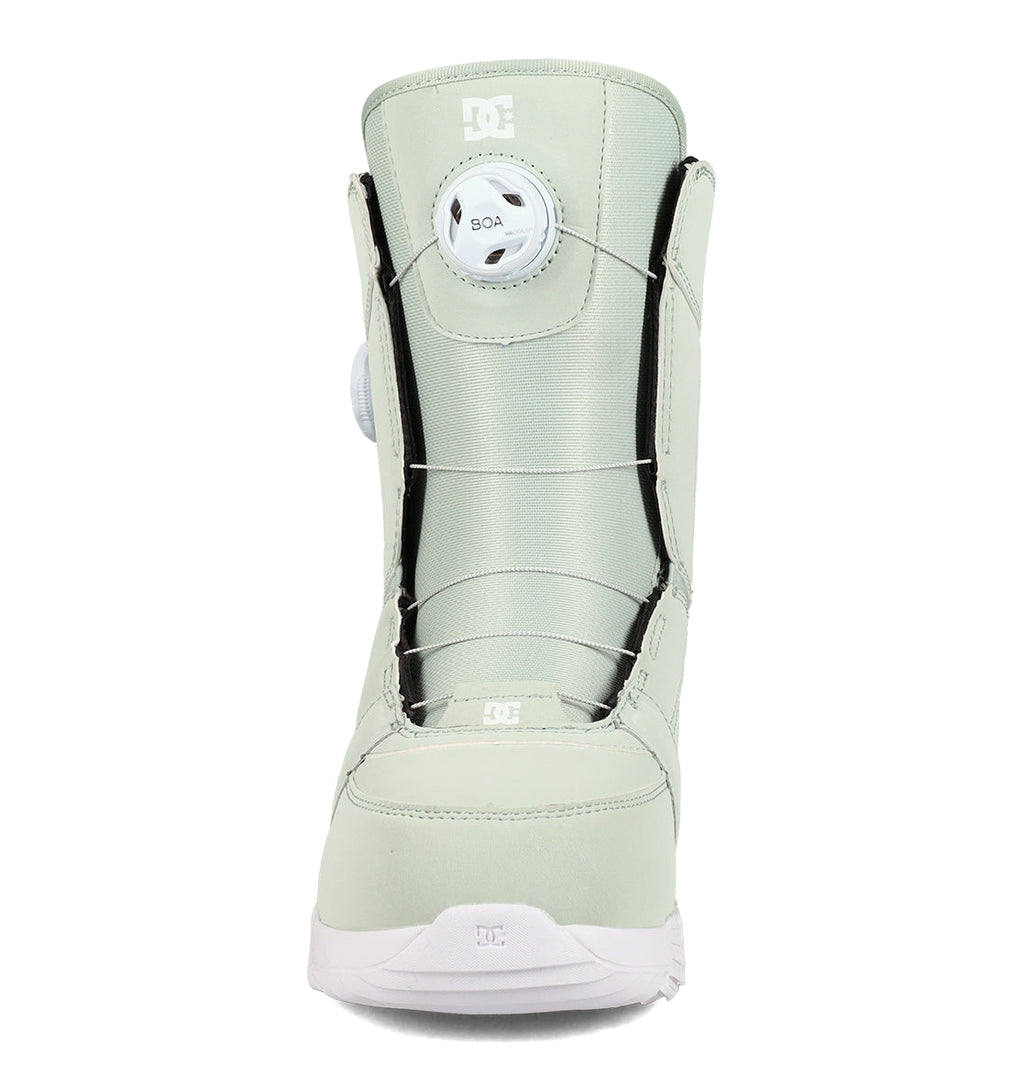 Front view of the DC Shoes Women’s Lotus Snowboard Boots in light gray, featuring a BOA lacing system with a round adjustment dial on the tongue and a white sole designed for enhanced support and comfort.