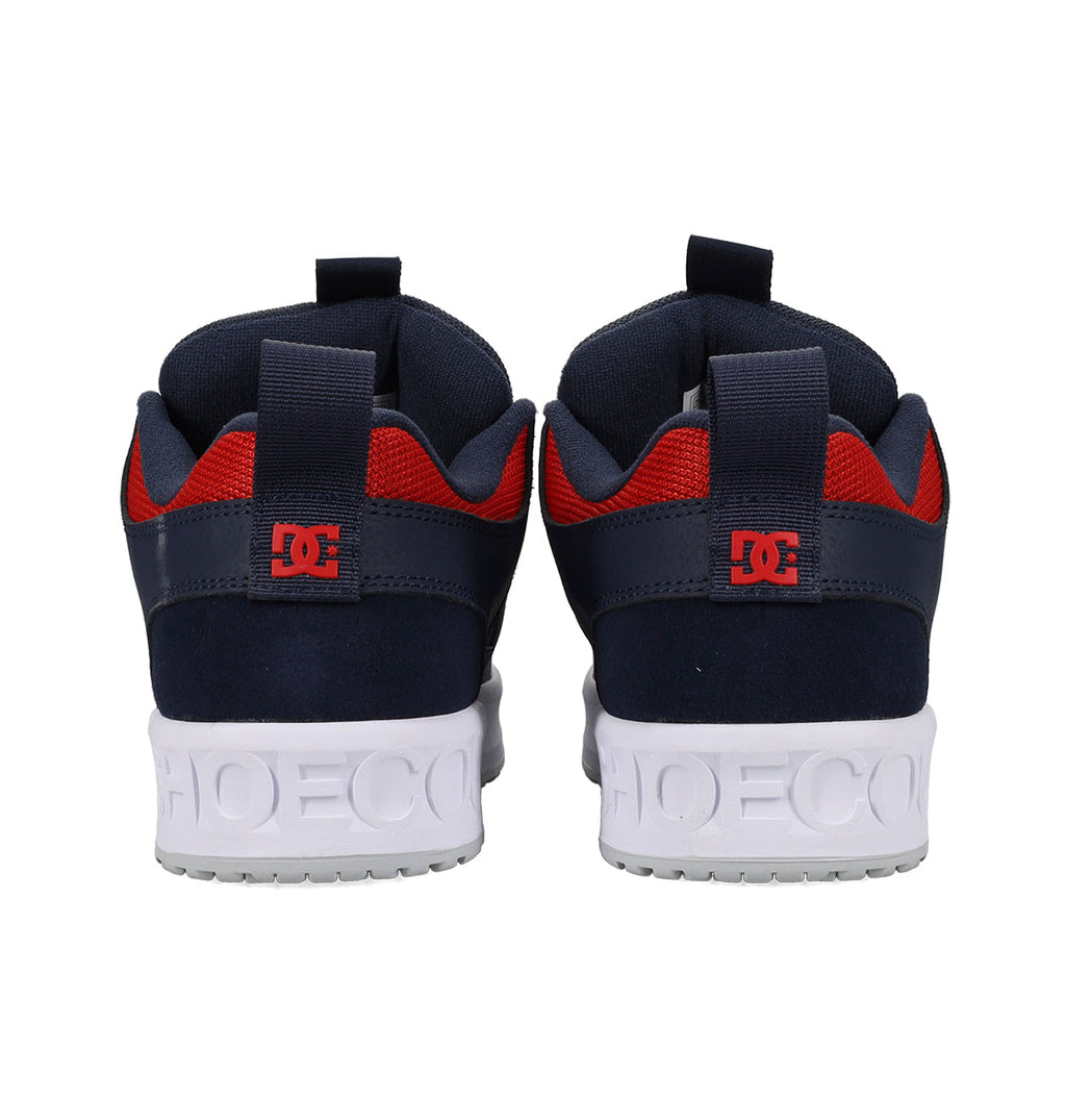 Navy and red sneakers with white soles on a white background