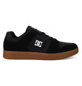 The Men’s Manteca 4 Shoes by DC Shoes are shown from the side on a plain white background, featuring a black upper with a white logo on the side and a brown rubber sole, designed for modern comfort and everyday wear.