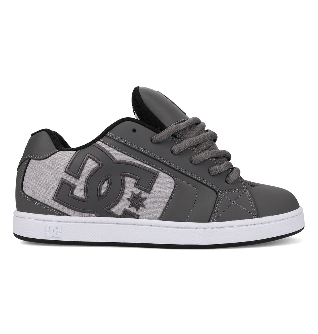 Men’s Net Shoes by DC Shoes shown in a side profile against a white background, featuring a large DC logo on the side, crafted from durable fabrics in gray and white with gray laces, a white sole, and black inner lining.