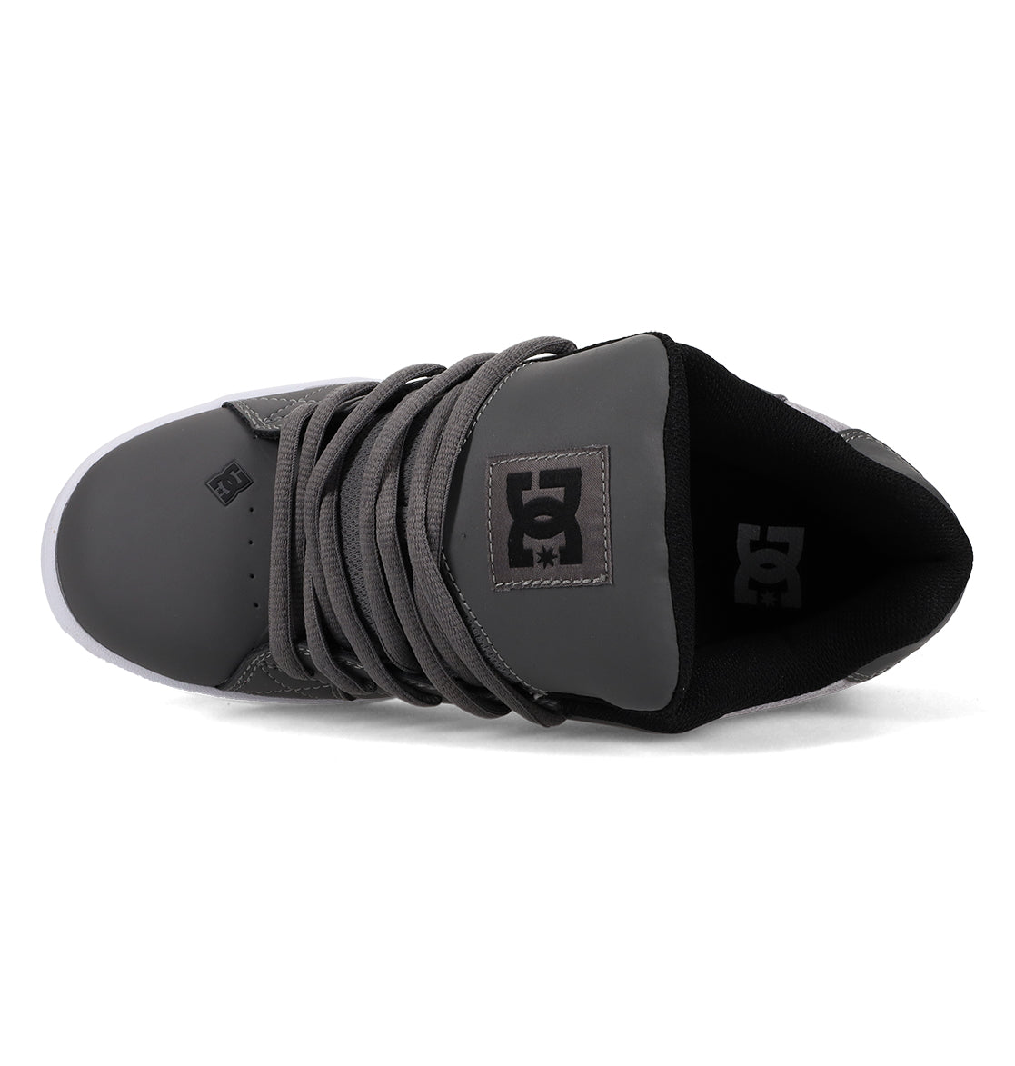 A top view of the Men’s Net Shoes by DC Shoes in gray, showcasing a black tongue with the signature DC Shoes logo, gray laces, and a white sole. These puffy sneakers are constructed from durable materials to ensure lasting comfort and style.