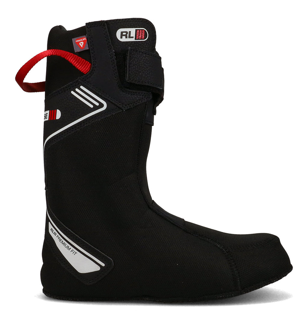 The DC Shoes Men’s Premier Hybrid Snowboard Boot liner is shown in a left-facing side profile on a plain white background. This black liner features white and red accents, a red pull loop at the top, a Velcro strap near the calf, and reinforced stitching—designed to deliver comfort and support for men’s snowboard boots.