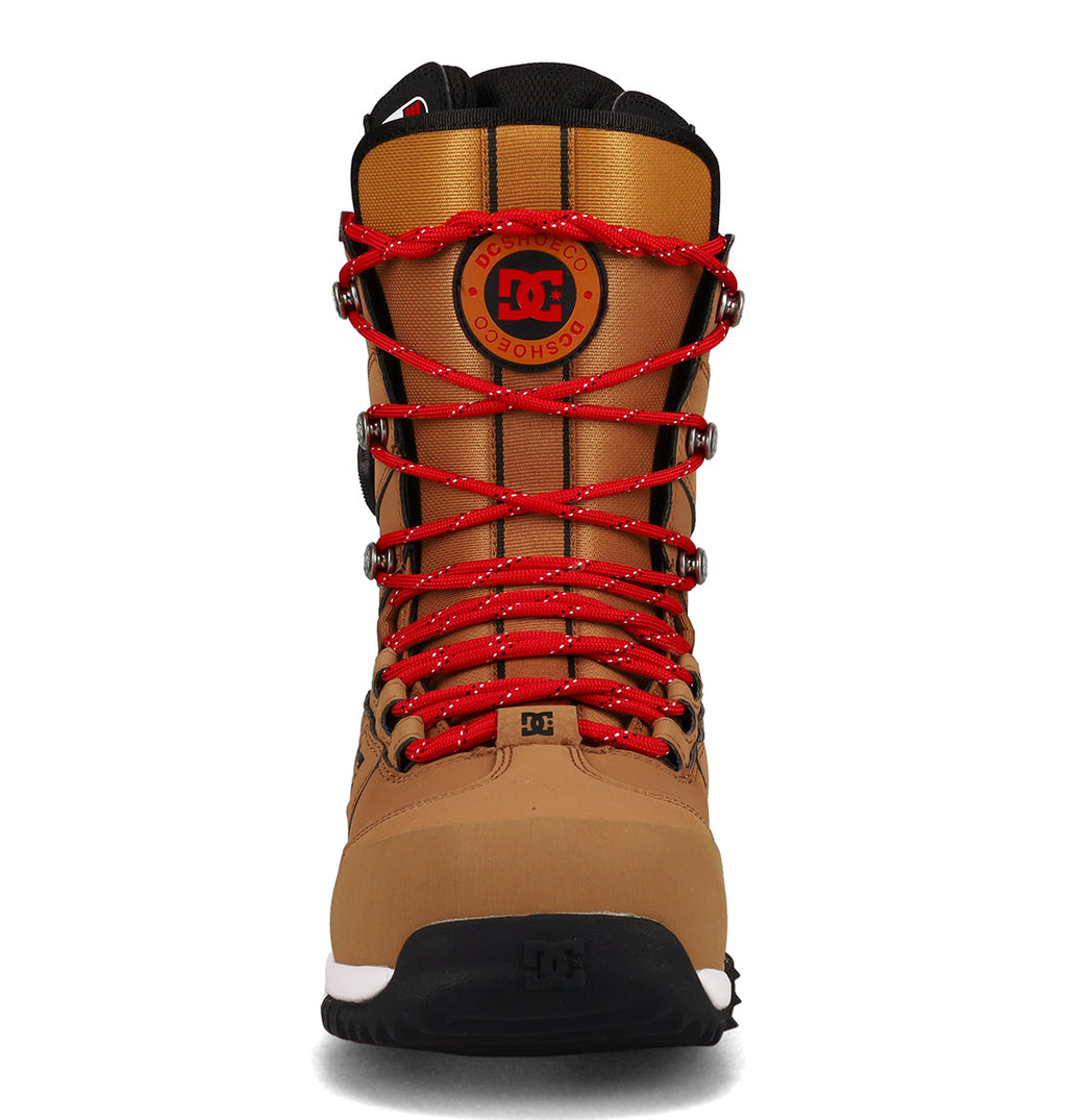 A front-facing view of the DC Shoes Men’s Premier Hybrid Snowboard Boots in tan and brown, featuring striking red laces, a black sole, and a round DC Shoes logo on the tongue—all set against a white background. Ideal for those looking for high-performance snowboarding boots that combine style and comfort.