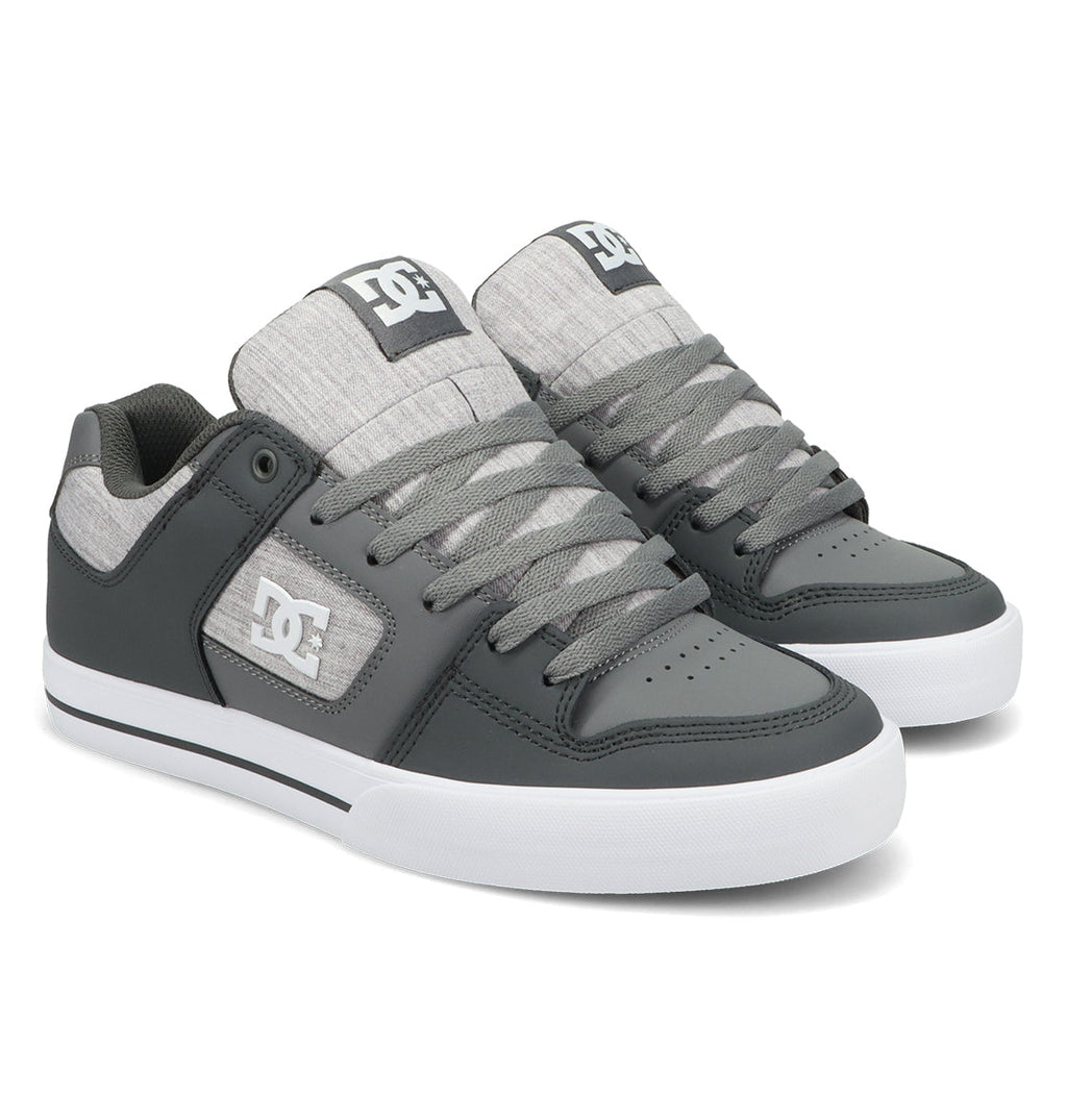 A pair of Men’s Pure Shoes by DC Shoes in gray, featuring white soles, white DC logos on the side and tongue, and gray laces, displayed against a white background—these versatile sneakers are designed for comfort and style, making them an excellent addition to any men’s shoe collection.