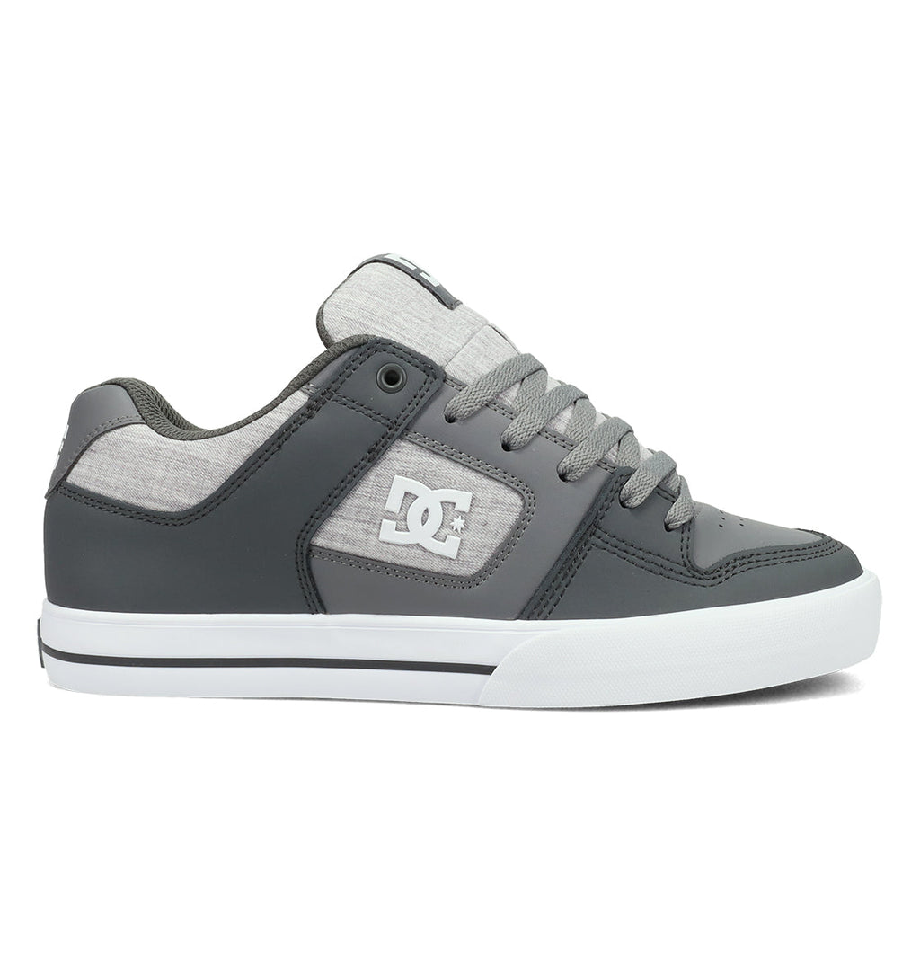 The DC Shoes Men’s Pure Shoes, featuring a gray colorway with a white logo, gray laces, and a white rubber sole, are displayed from the side on a white background—making these comfortable sneakers a versatile addition to any wardrobe.