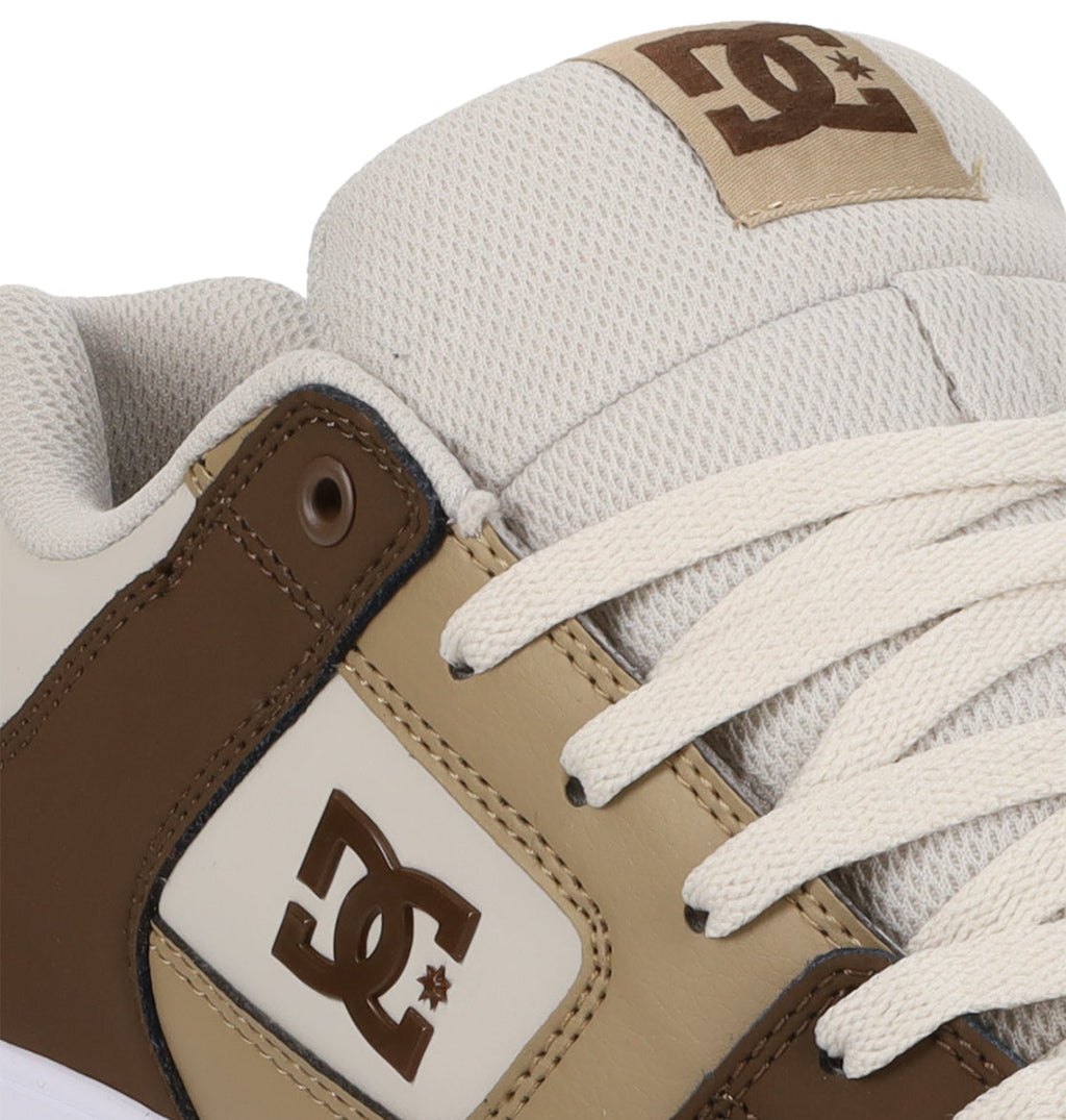 Close-up of the Men’s Pure Shoes by DC Shoes in beige and brown, highlighting the DC logo on the side panel and tongue, white laces, and textured fabric around the ankle—an excellent choice for anyone looking for comfortable men’s footwear with versatile style.