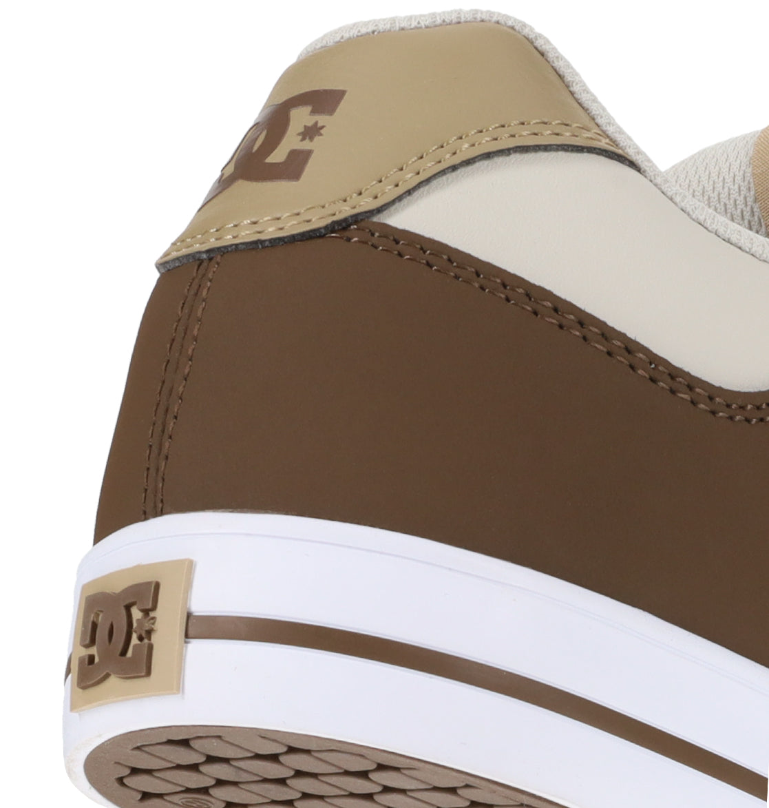 Close-up of the heel of a brown, beige, and white Men’s Pure Shoe from DC Shoes, showcasing the DC logo on the heel and back. Features a textured white sole for comfortable wear—ideal for anyone seeking versatile footwear that seamlessly blends style and function.