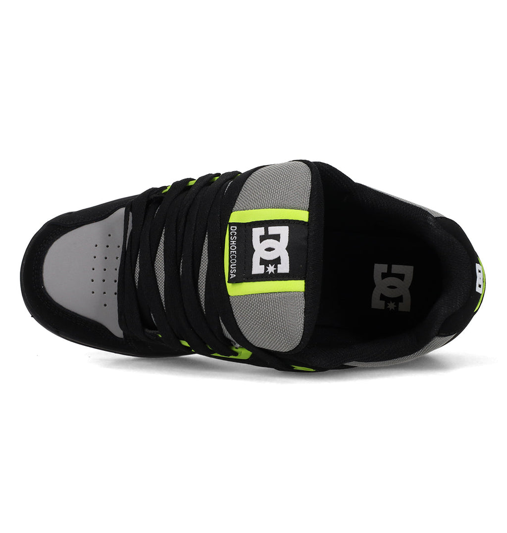 Top view of the Men's Stag Shoes by DC Shoes in black and gray with neon green accents, black laces, visible DC Shoes logos on the tongue and insole, and a durable cupsole for added support.