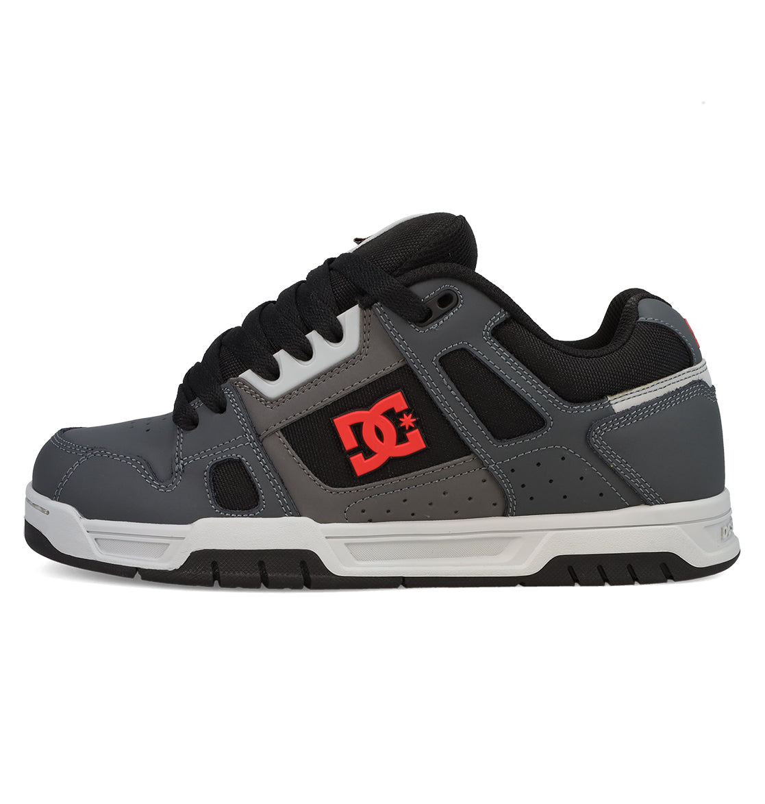 The Men’s Stag Shoes by DC Shoes feature a gray and black design with black laces, a white sole, and a red DC Shoes logo on the side. Drawing inspiration from skate culture, these shoes include a padded collar, visible stitching details, and durable cupsole construction for long-lasting comfort and grip.