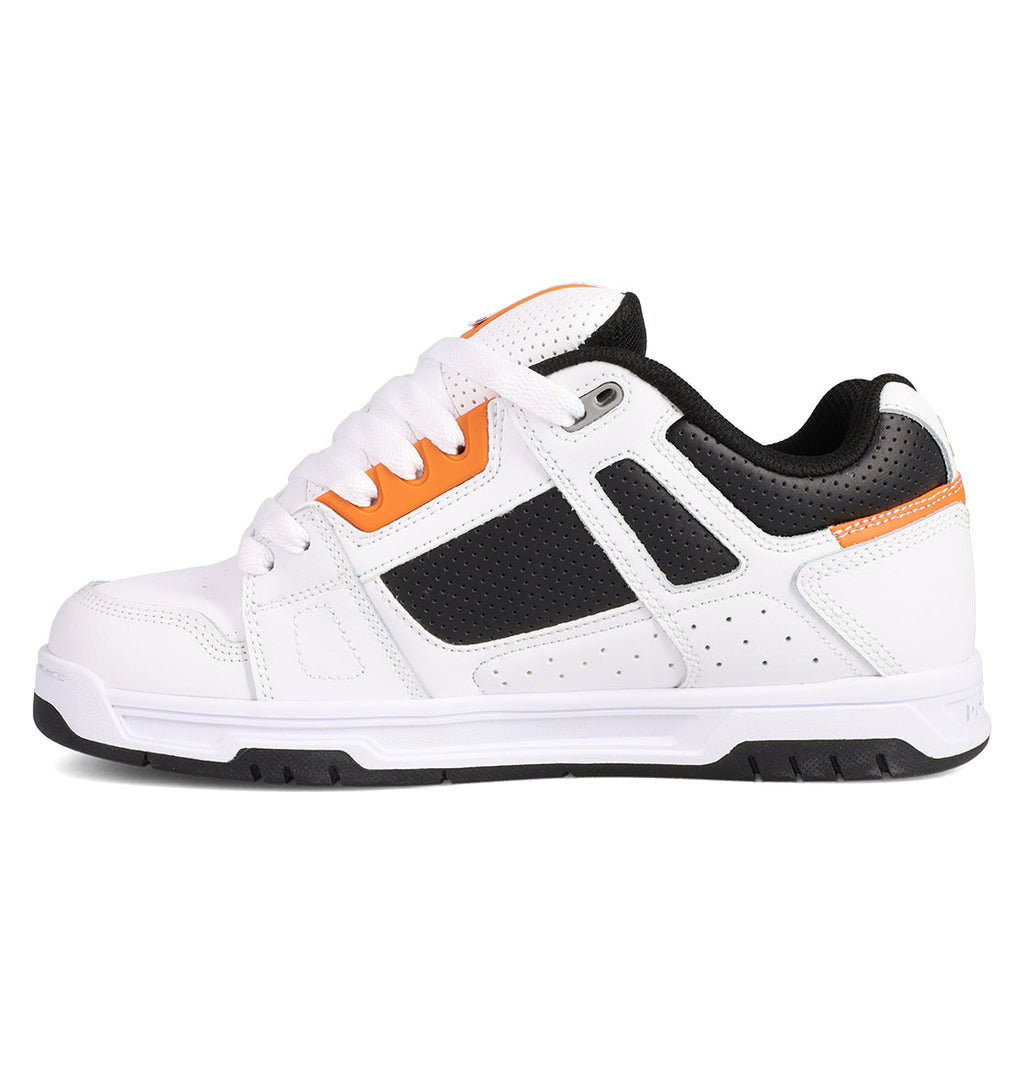 The Men's Stag Shoes by DC Shoes are white athletic sneakers with black and orange accents, black perforated side panels, white laces, a durable cupsole, and a thick treaded sole—delivering essential skate culture style.