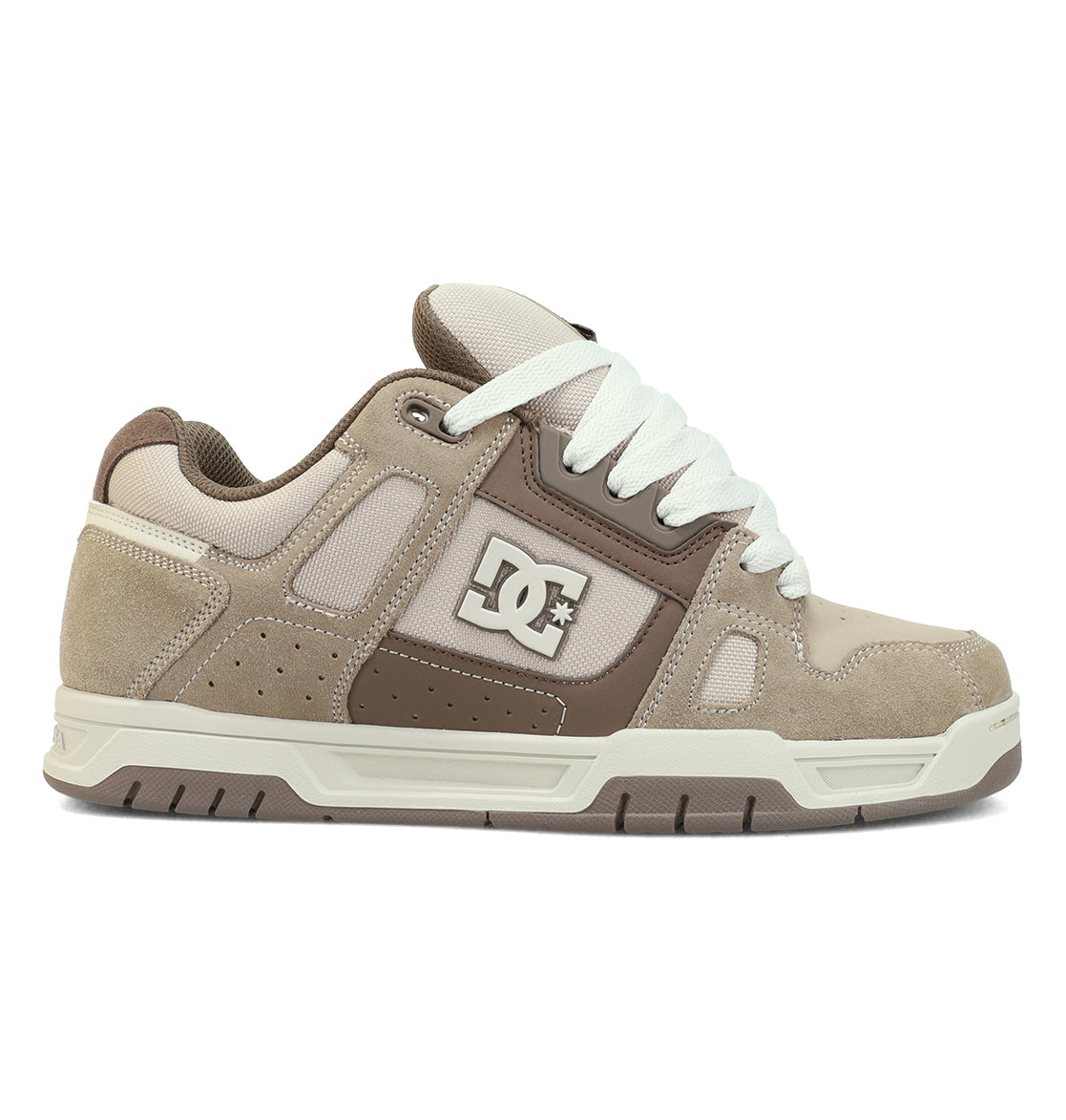 The Men’s Stag Shoes by DC Shoes showcase a beige and brown color scheme with white laces and the signature DC logo on the side. Crafted from a combination of suede and mesh, these skate shoes feature an oversized puff tongue for enhanced comfort. The durable cupsole outsole comes in light beige with brown accents, making them both stylish and functional for skating.