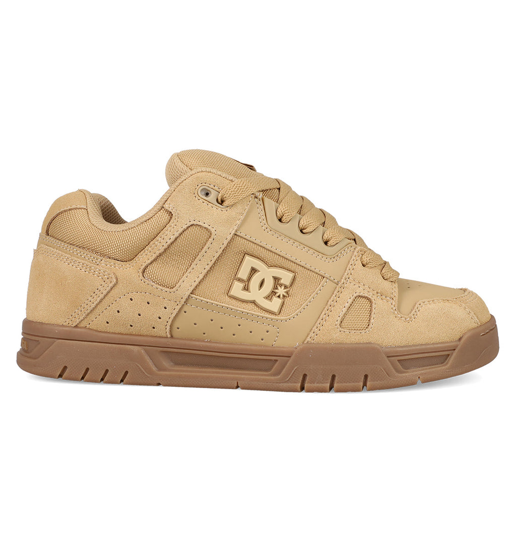 The Men's Stag Shoes by DC Shoes feature a tan and brown design, chunky cupsole, mesh and suede accents, laces, low-top profile, and signature DC logo—a stylish nod to classic skate culture.