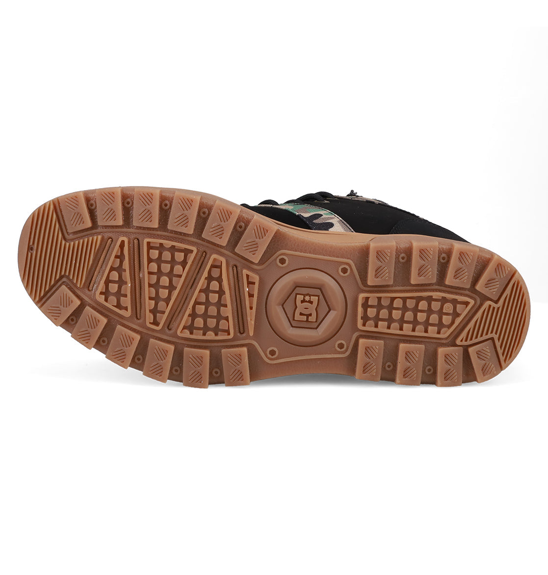 The image displays the brown rubber sole of a DC Shoes Men's Woodland Winter Boot, featuring a textured tread for grip and a central logo. The boot is shown sole-up to highlight the full bottom surface.
