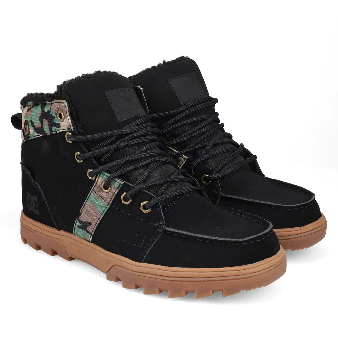 The DC Shoes Men's Woodland Winter Boots feature black uppers, tan rubber soles, black laces, green camo ankle accents, metal eyelets, and a rugged design—ideal for outdoor winter wear.