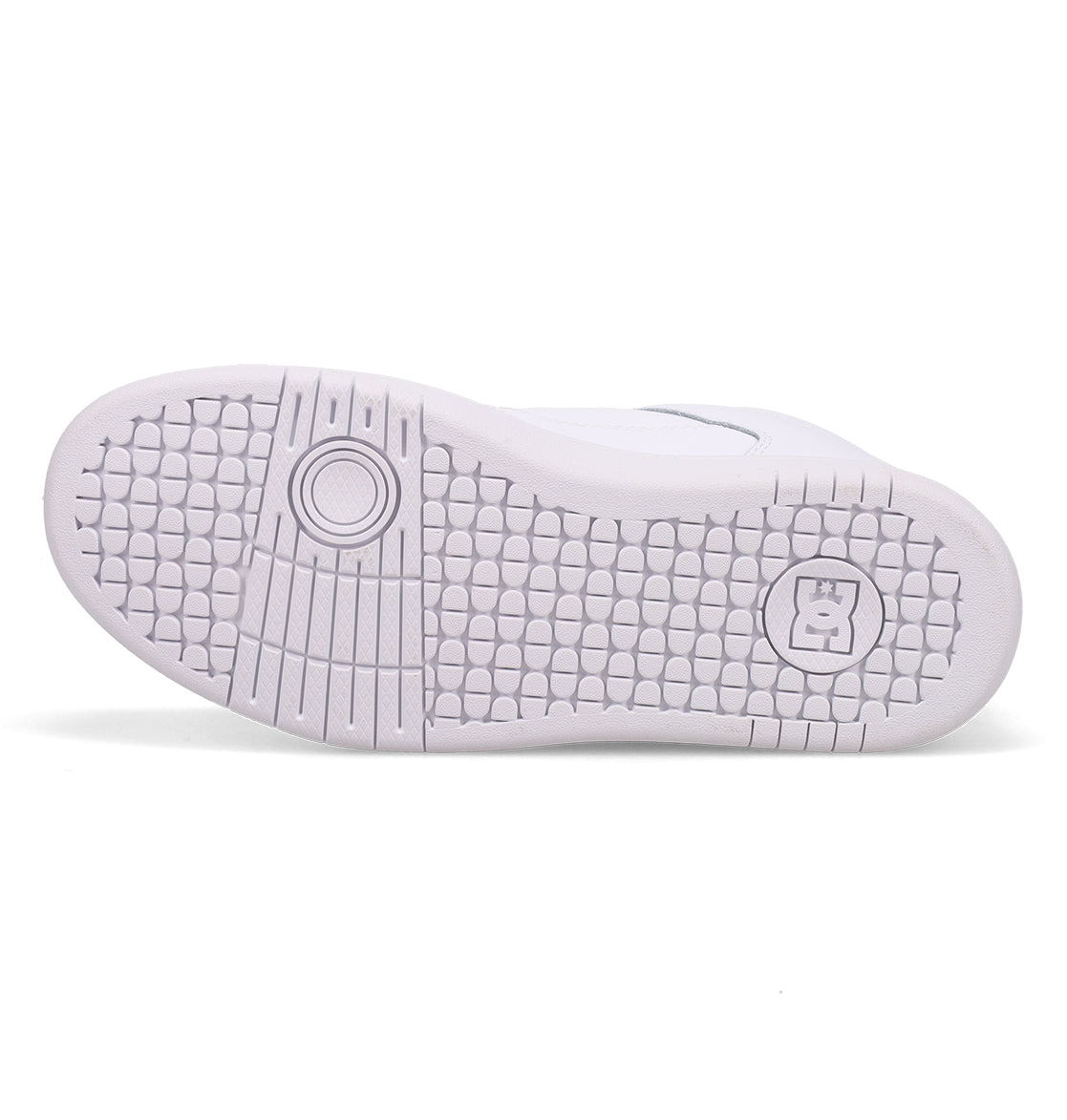 The image displays the white rubber sole of the Women’s Manteca 4 Hi High-Top Shoes by DC Shoes, highlighting a textured honeycomb pattern along with two circular designs—one near the toe and another near the heel—that showcase its performance-oriented design.