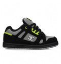The DC Shoes Kids' Stag is a low-top skate shoe in black, grey, and neon green with a minimal silhouette, thick sole, mesh detailing, black laces, and the DC Shoes logo—perfect for everyday wear.